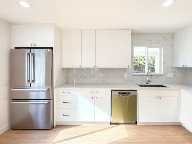 a kitchen with a refrigerator and a sink