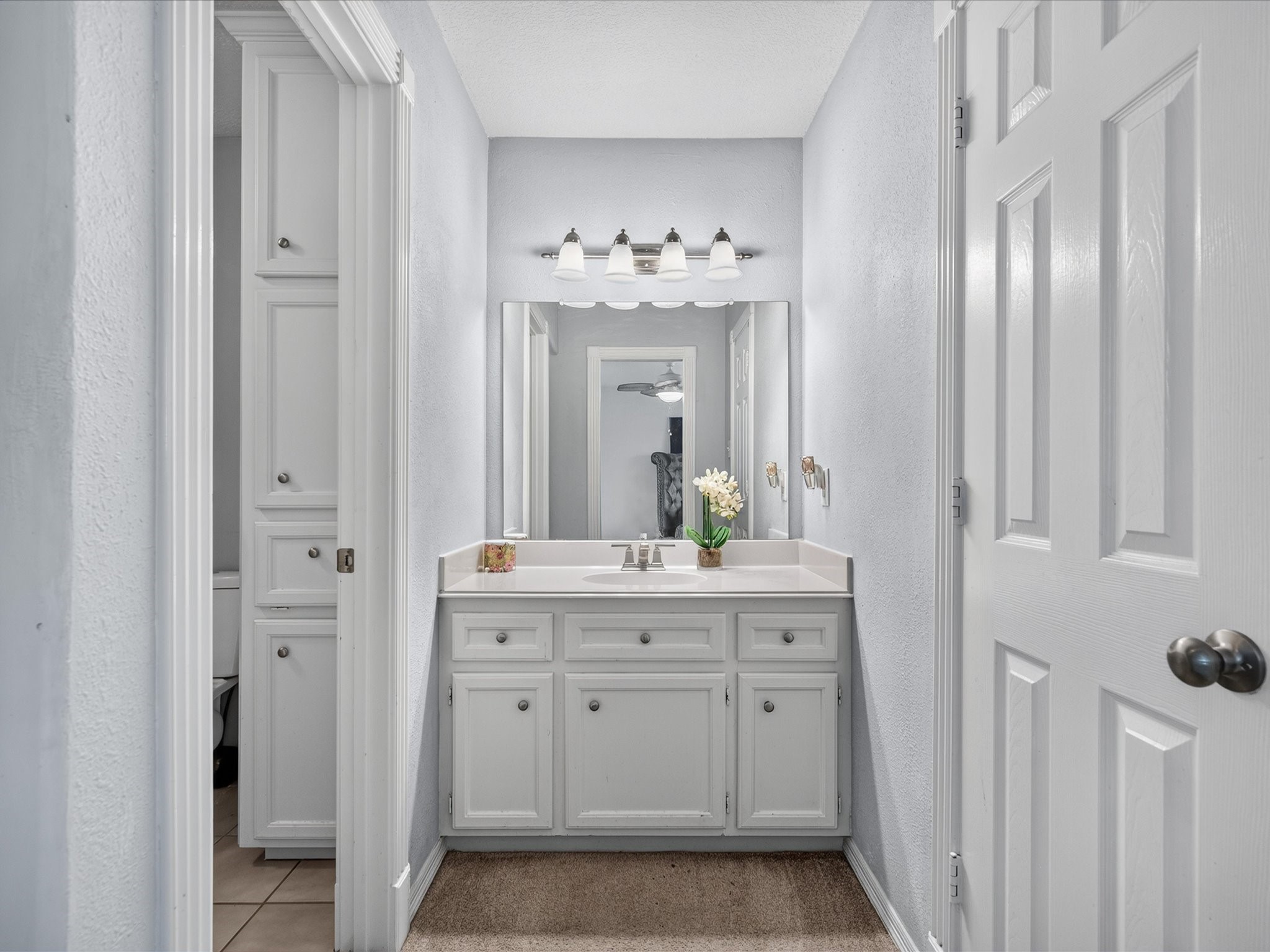 16123 Lafone Drive Spring, TX 77379 - Photo 30 of 47 An additional vanity area enhances the shared bath arrangement, offering extra space and convenience for busy mornings.