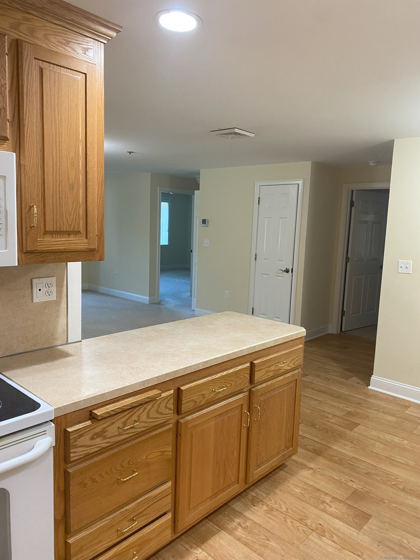 380 Main Street, Unit 14 Wallingford, CT 06492 - Photo 4 of 12 a kitchen with stainless steel appliances granite countertop a sink and cabinets