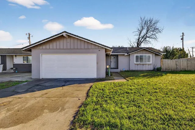 a view of a house with a yard and garage