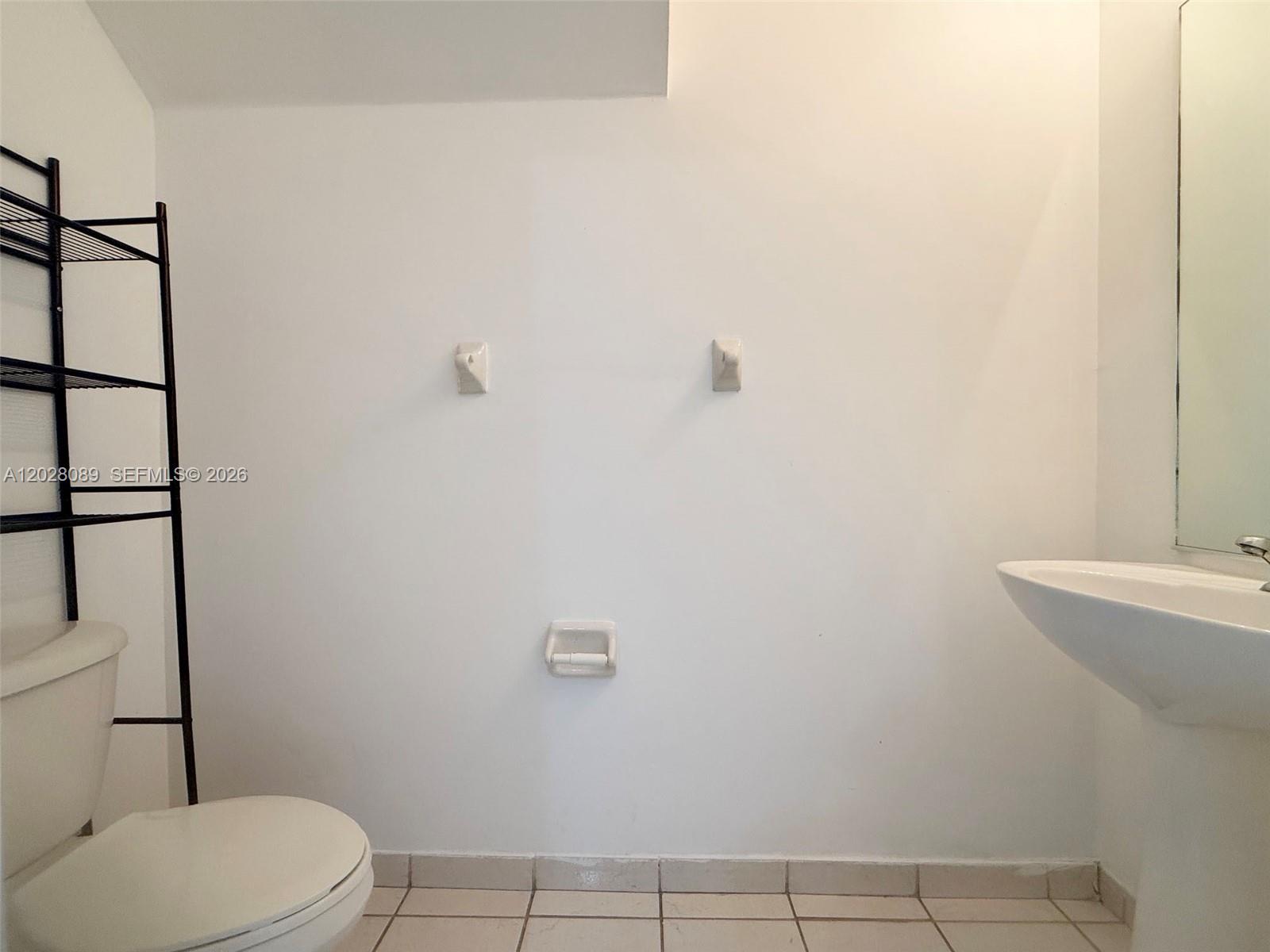 662 Northeast 21st Terrace Homestead, FL 33033 - Photo 34 of 34 a white toilet sitting next to a bathroom sink