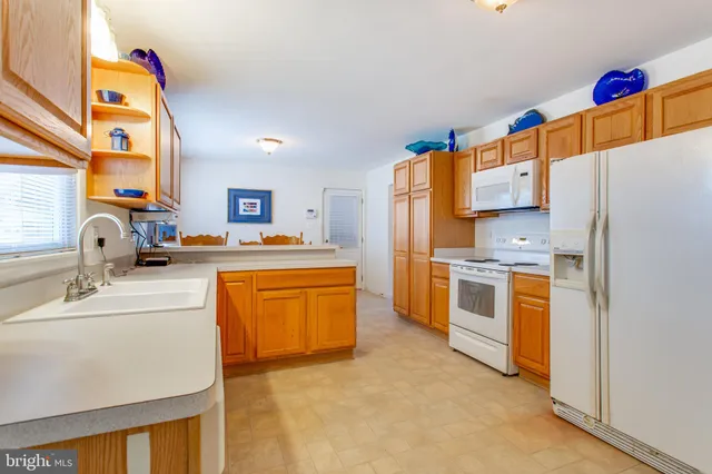 a spacious bedroom with a bed and a chandelier