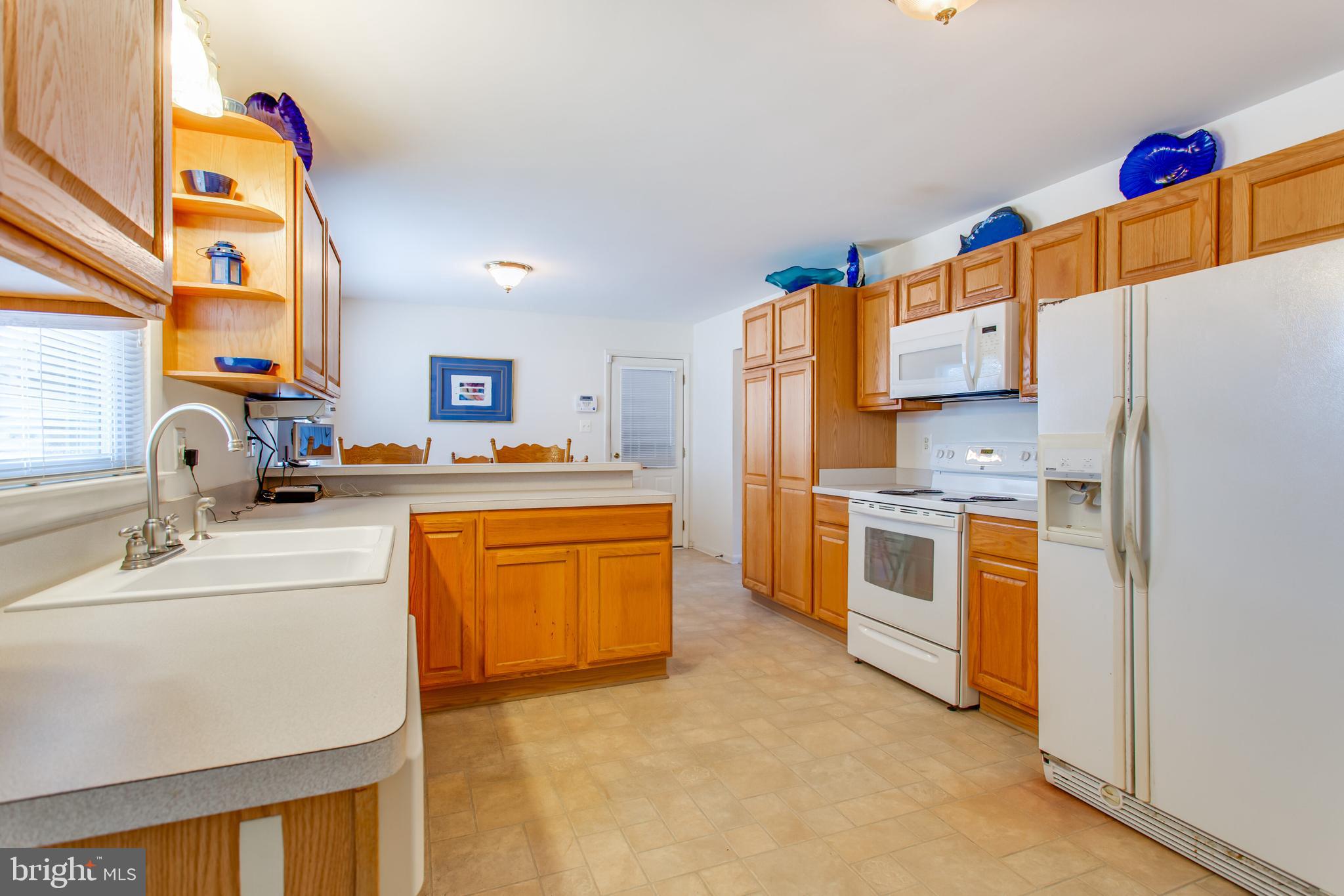 2784 Moran Drive Waldorf, MD 20601 - Photo 14 of 65 a kitchen with stainless steel appliances a stove a sink and a refrigerator
