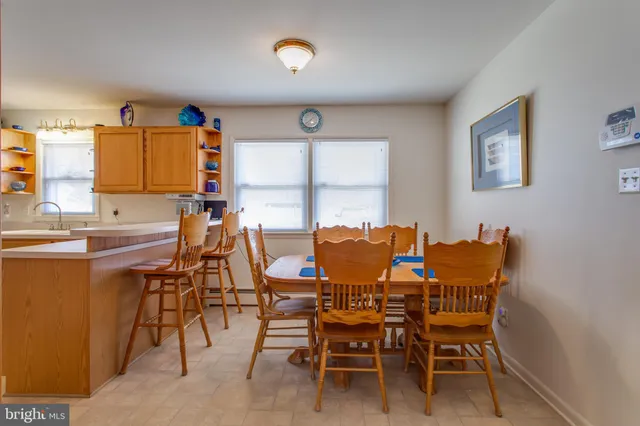 a view of a dining room with furniture and a window