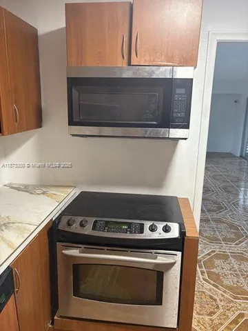 a stove top oven sitting inside of a kitchen