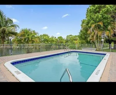 a view of a swimming pool with a yard