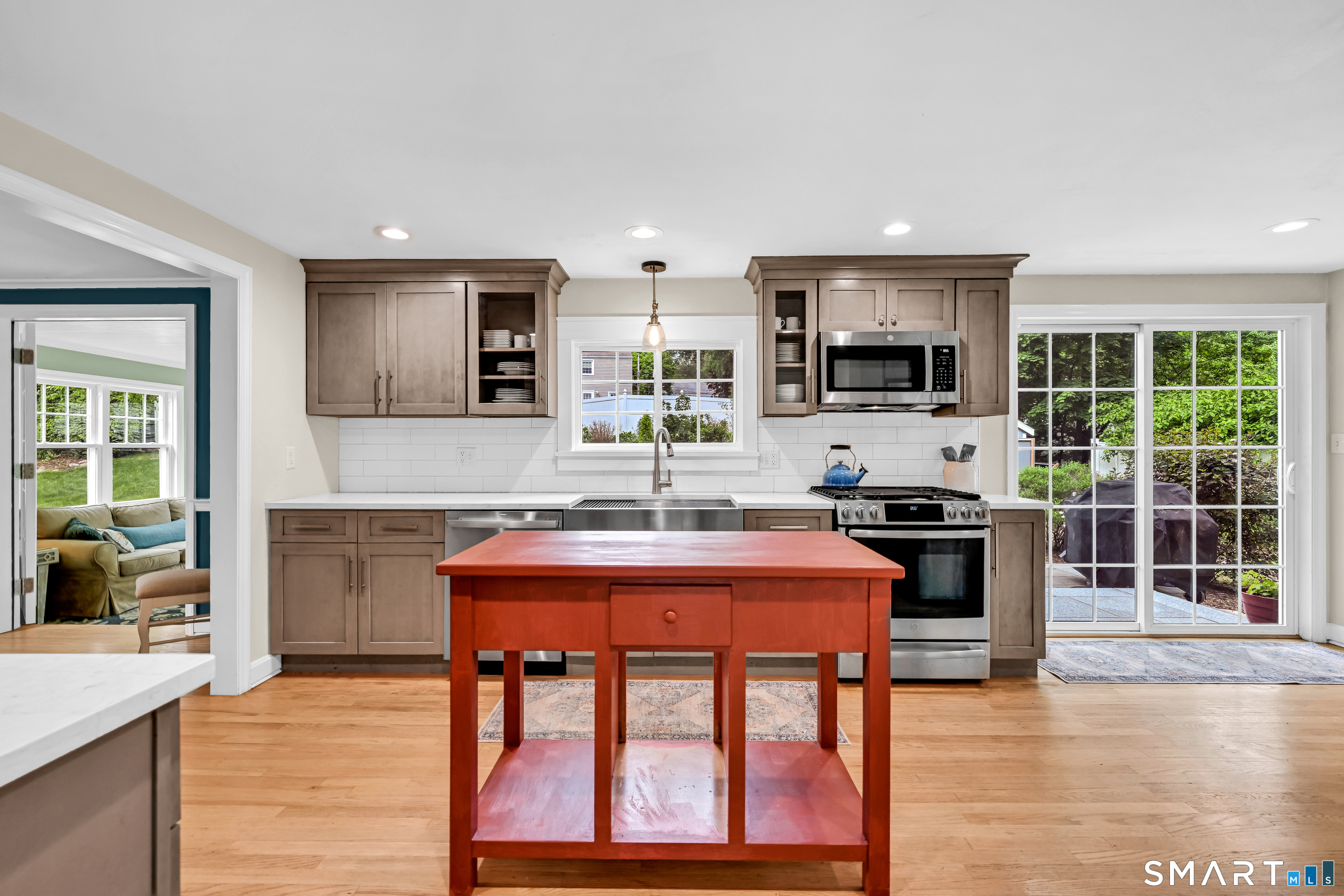 47 Spring Lane West Hartford, CT 06107 - Photo 10 of 38 a kitchen with stainless steel appliances granite countertop a stove top oven a sink dishwasher a dining table and chairs with wooden floor