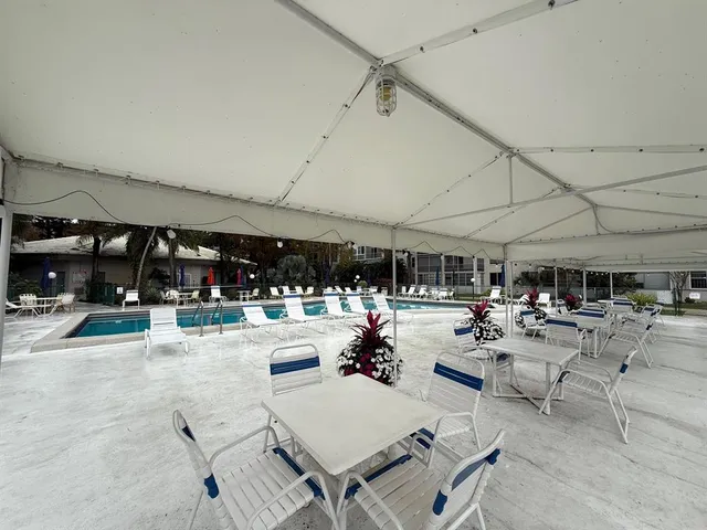 a living room with lots of furniture a table and chairs