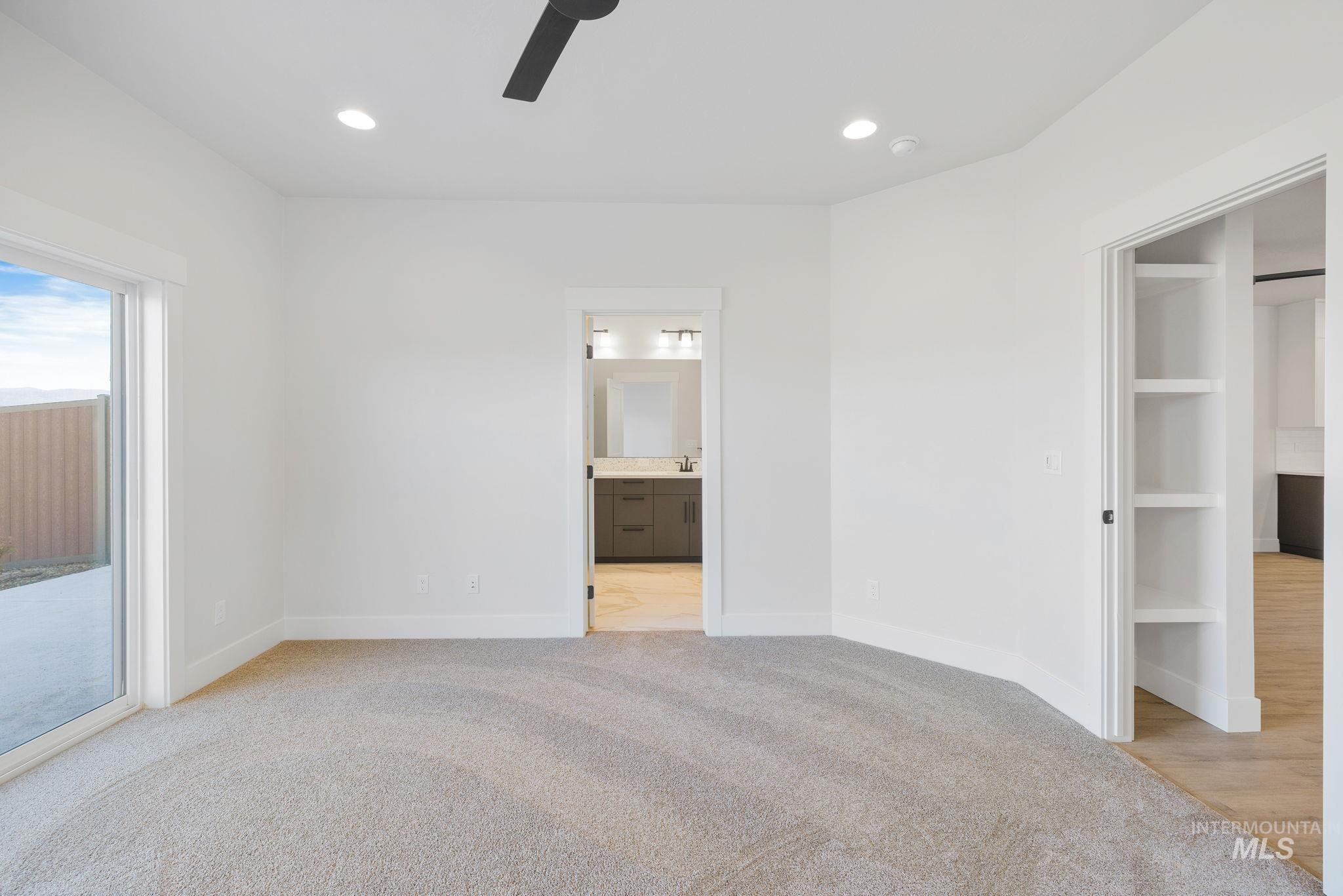 24 Bridger Street Cascade, ID 83611 - Photo 21 of 39 Unfurnished bedroom featuring light colored carpet, recessed lighting, access to outside, ceiling fan, and connected bathroom