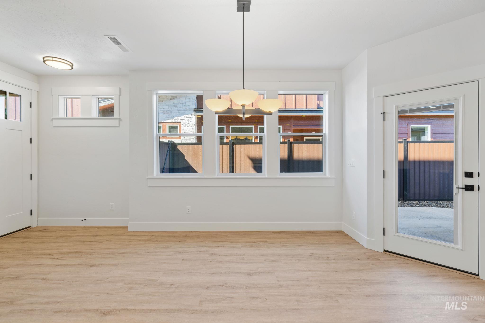 24 Bridger Street Cascade, ID 83611 - Photo 9 of 39 Unfurnished dining area with light wood-type flooring and a chandelier