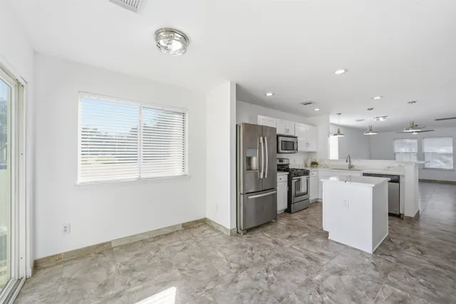 a dining room with furniture and window