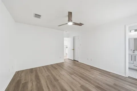 a bedroom with a beds chandelier and a window