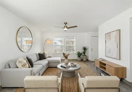 a view of a livingroom with a ceiling fan and window