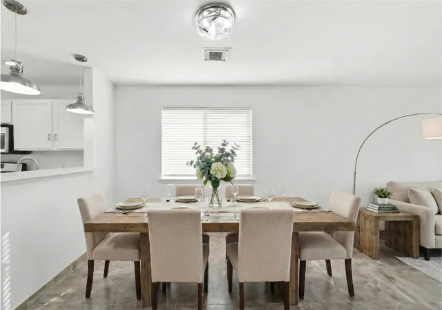 a living room with furniture a clock and a large window