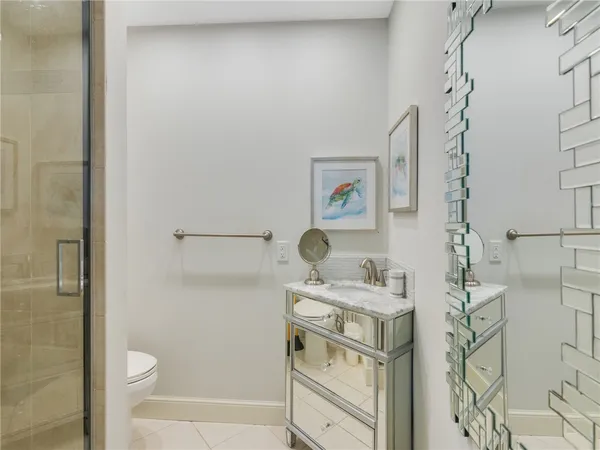 a white toilet sitting next to a bathroom sink