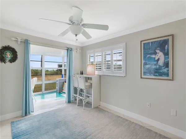 a view of a livingroom with wooden floor and a ceiling fan