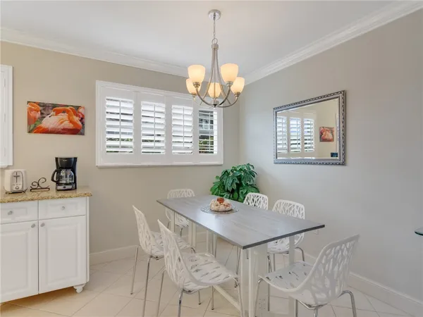 a kitchen with white cabinets and refrigerator
