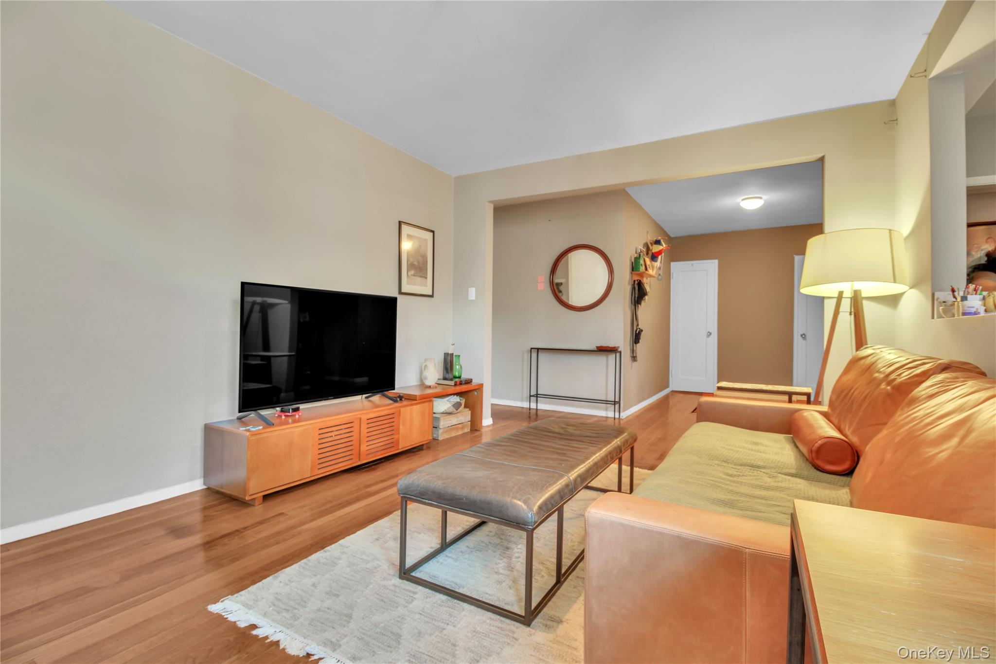 35-40 75th Street, Unit 5B Queens, NY 11372 - Photo 3 of 20 a living room with furniture and a flat screen tv