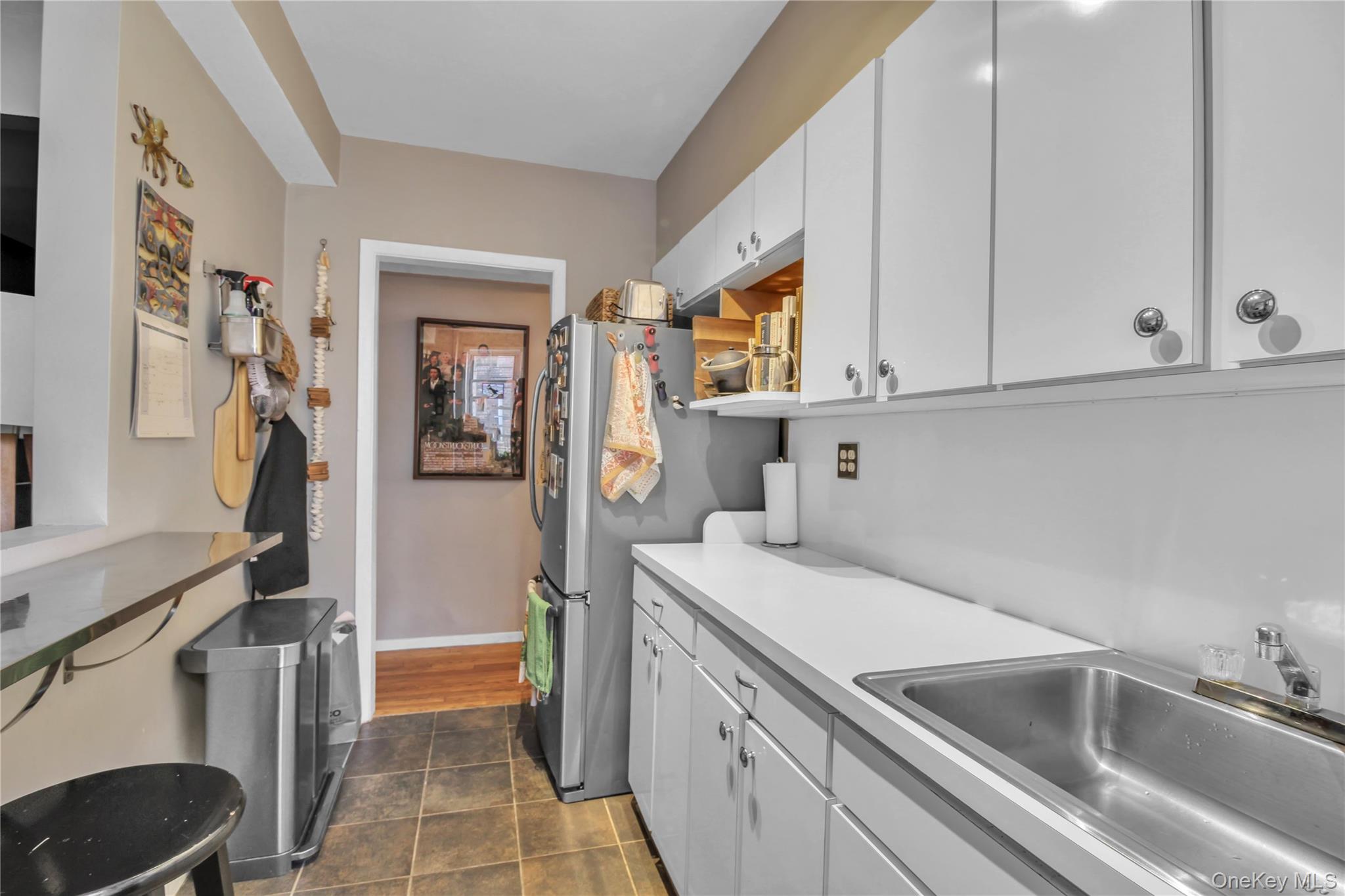 35-40 75th Street, Unit 5B Queens, NY 11372 - Photo 6 of 20 a view of a kitchen with sink and washing machine