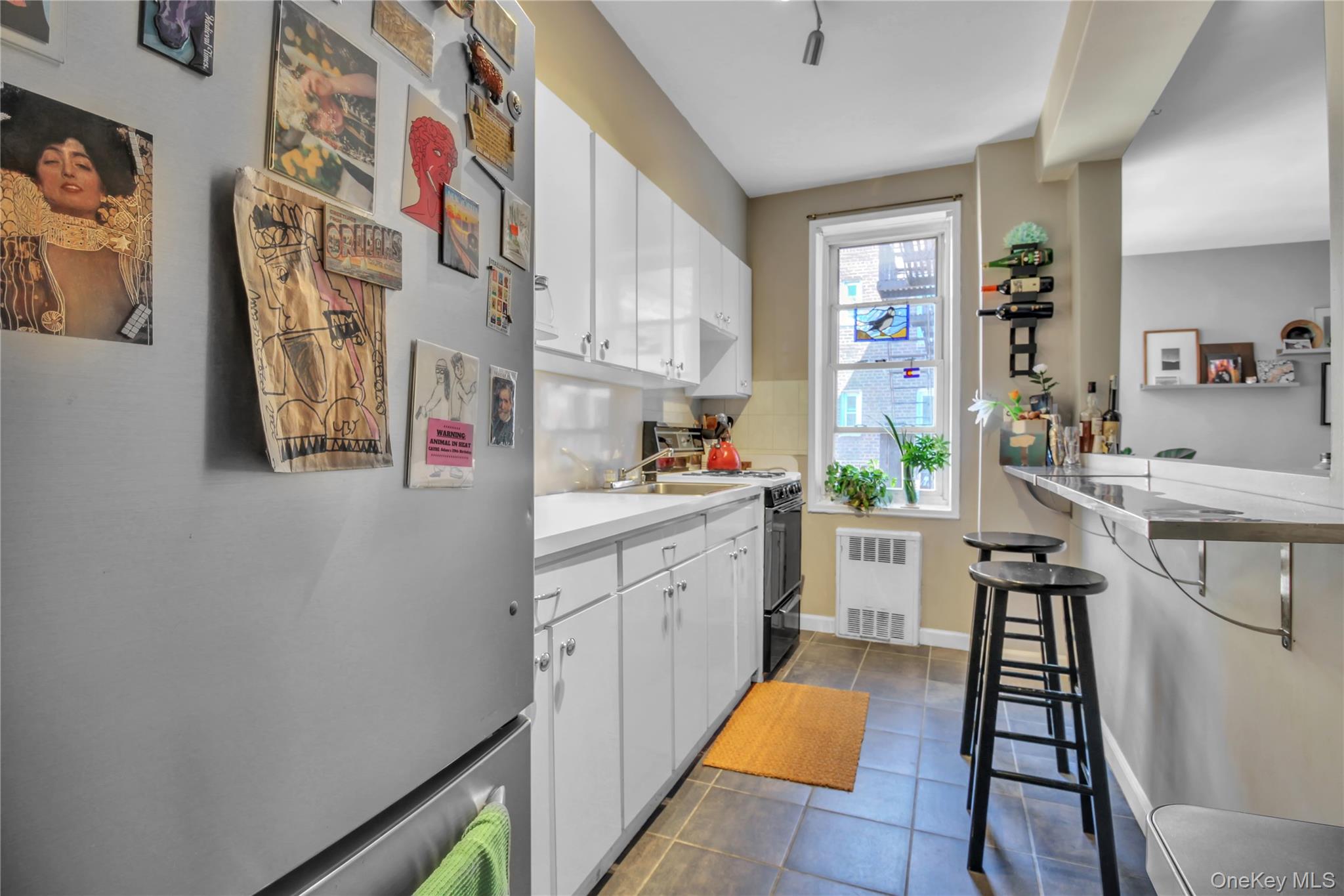 35-40 75th Street, Unit 5B Queens, NY 11372 - Photo 7 of 20 a kitchen with stainless steel appliances a sink and a refrigerator