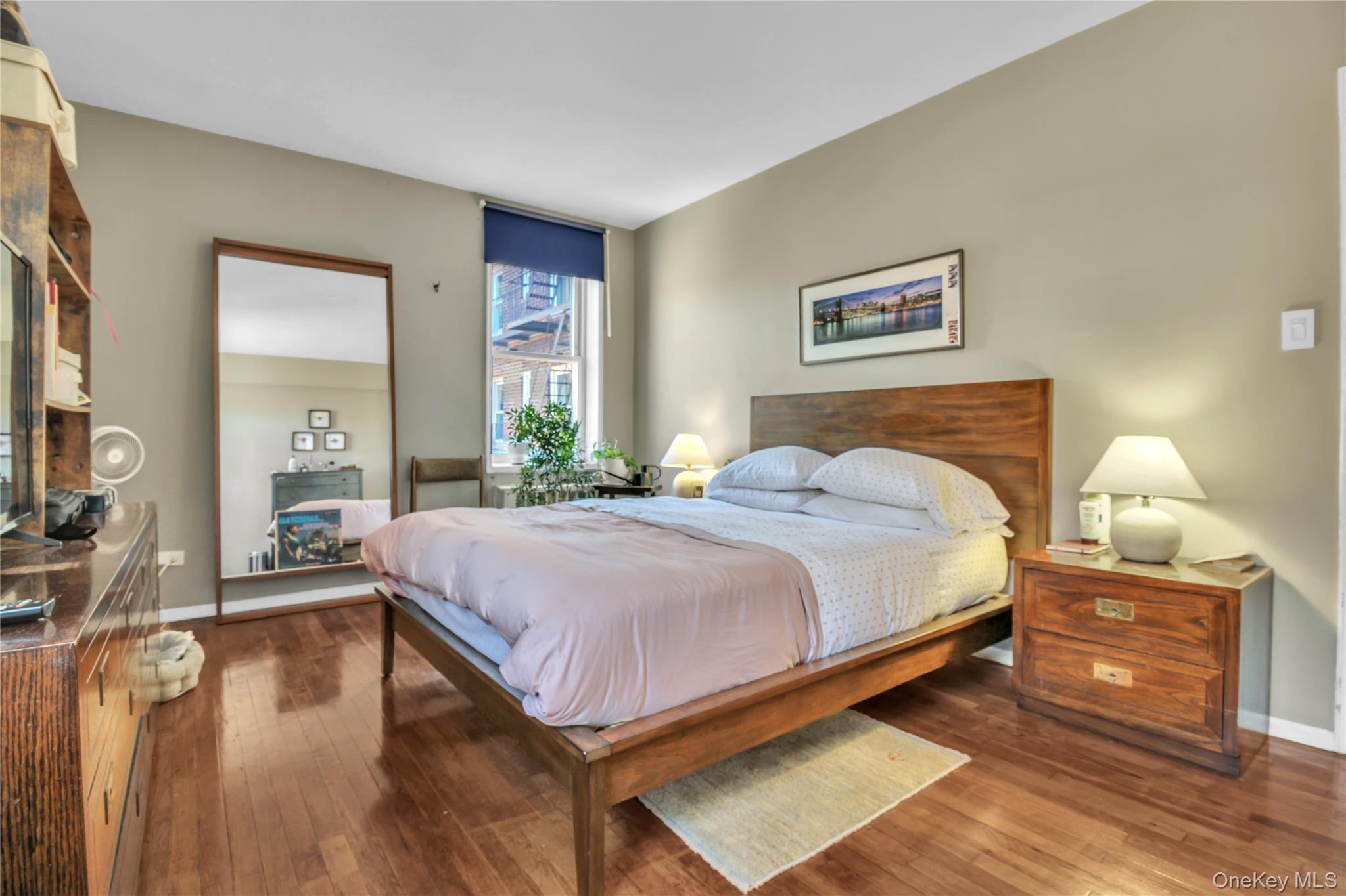 35-40 75th Street, Unit 5B Queens, NY 11372 - Photo 8 of 20 a bedroom with a bed and wooden floor