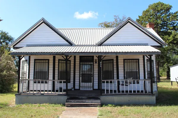 a view of a house with wooden floor in front of house