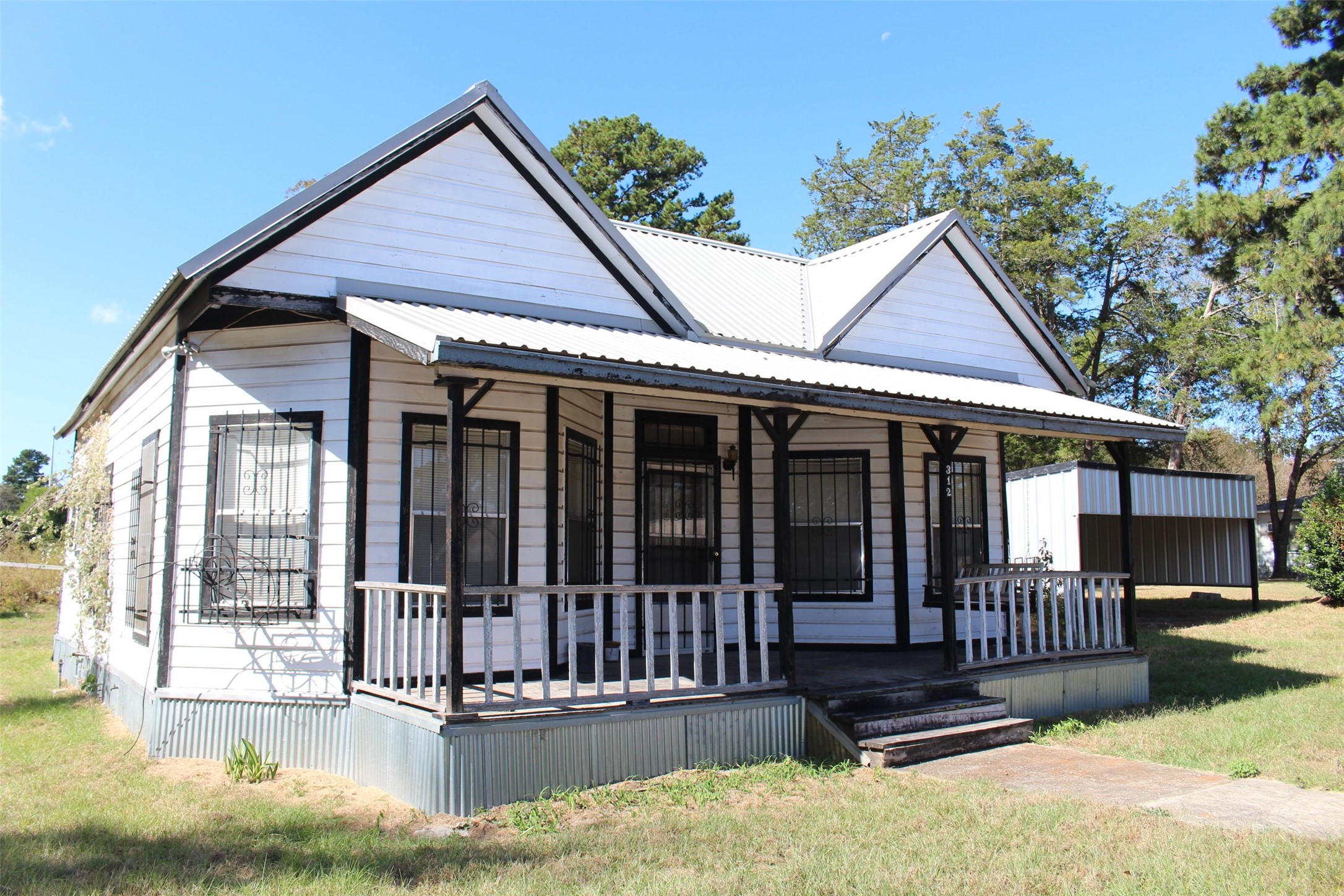 312 North Howard Street Grapeland, TX 75844 - Photo 2 of 29 a view of a house with wooden floor and a yard with plants