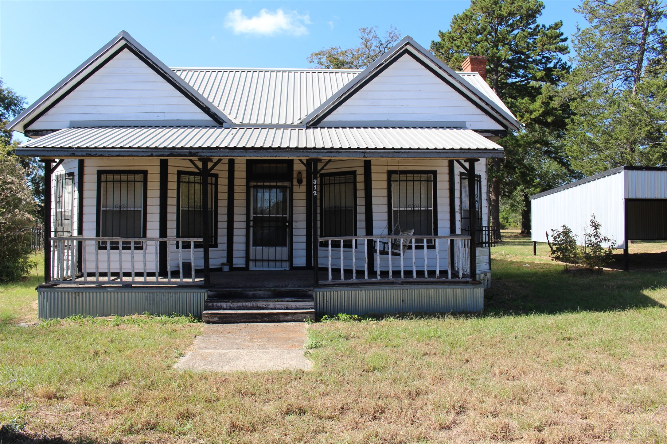 312 North Howard Street Grapeland, TX 75844 - Photo 28 of 29 a view of a house with large windows and a yard