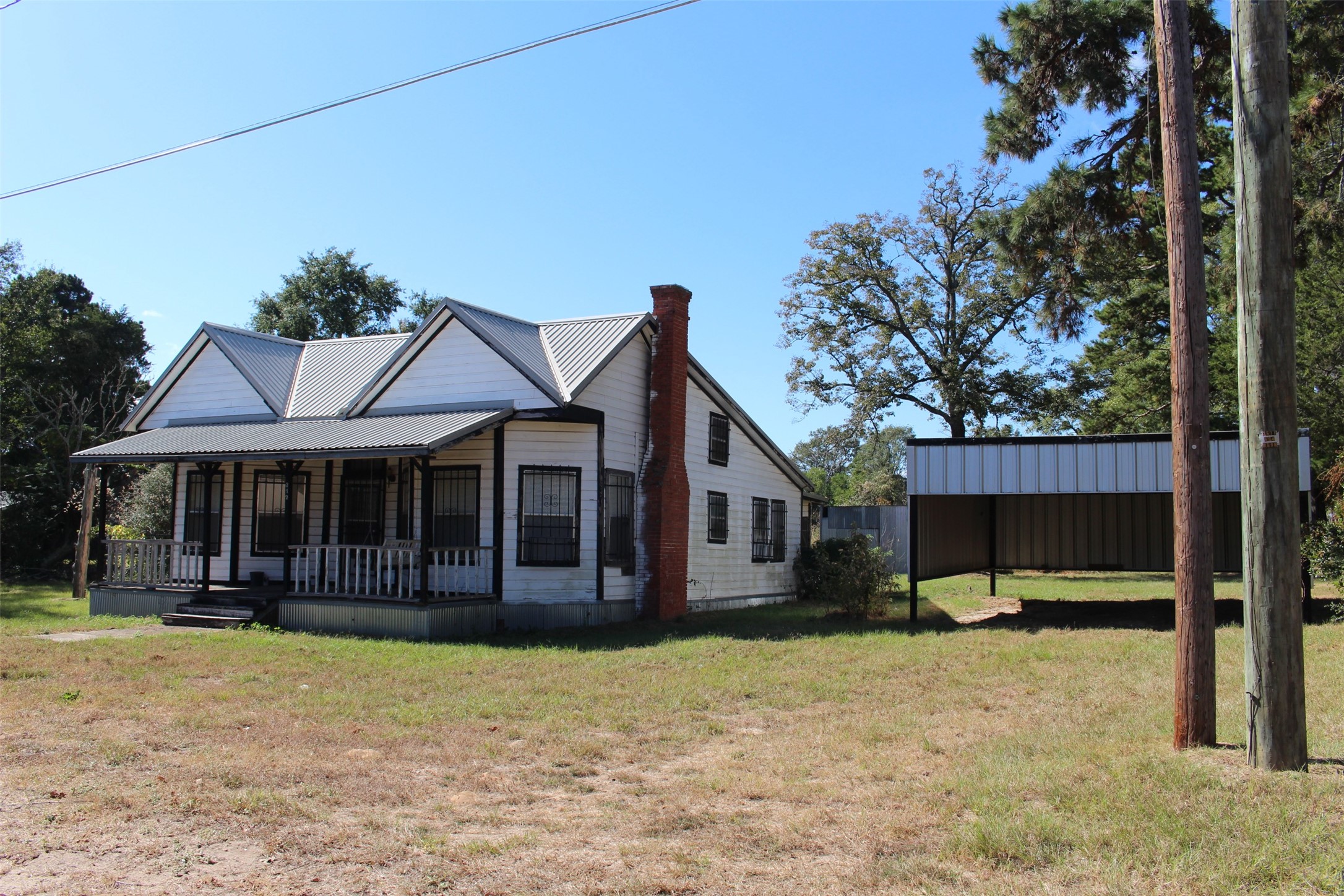 312 North Howard Street Grapeland, TX 75844 - Photo 4 of 29 a view of a house with a backyard and porch