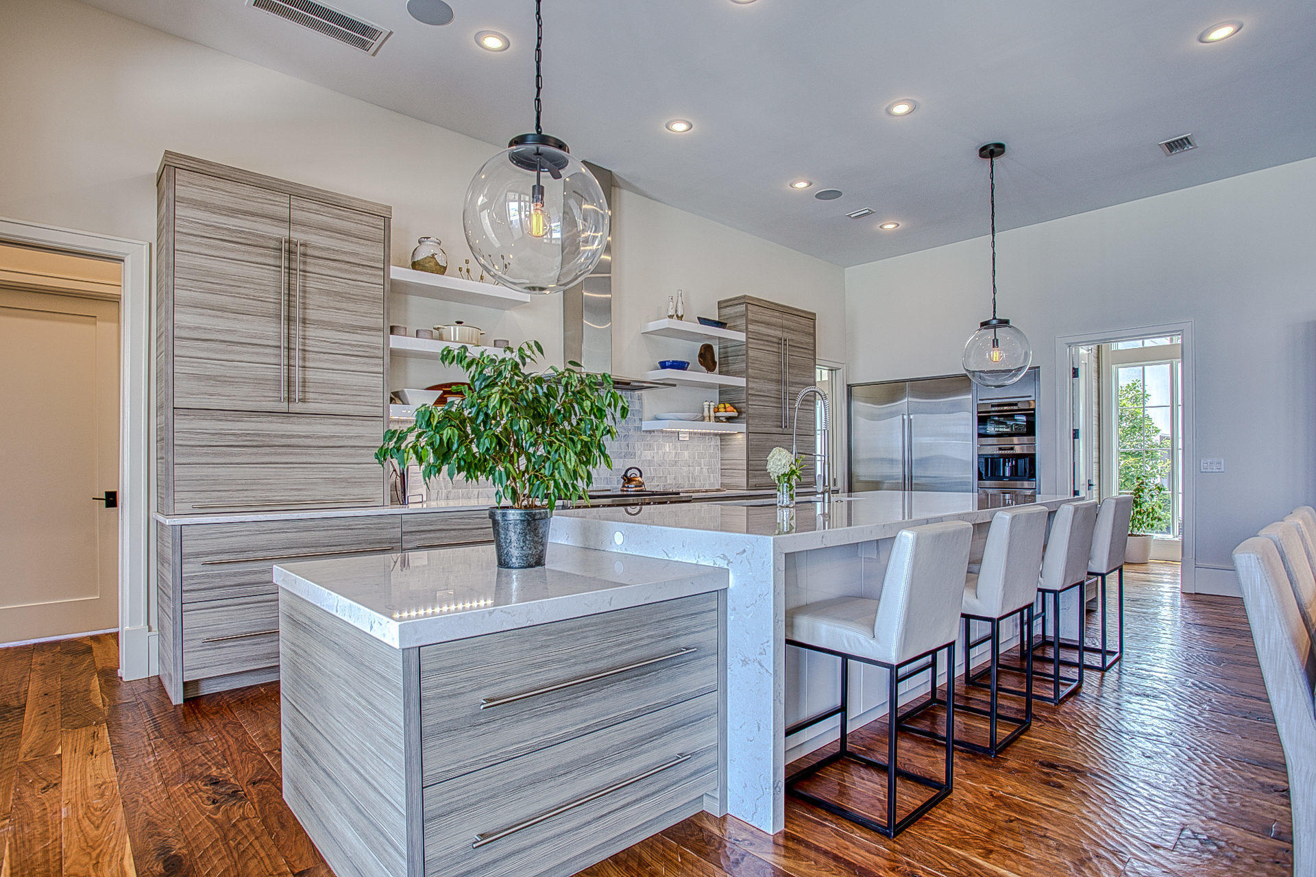 1023 Driftwood Point Road Santa Rosa Beach, FL 32459 - Photo 13 of 38 a kitchen with stainless steel appliances kitchen island granite countertop a table chairs and a refrigerator
