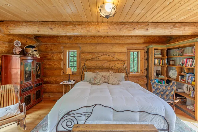 a bedroom with a large bed and a large window