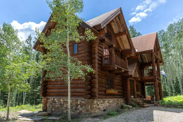 a view of a house with wooden fence