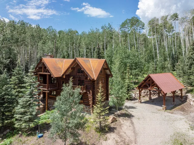 a front view of a house with a tree
