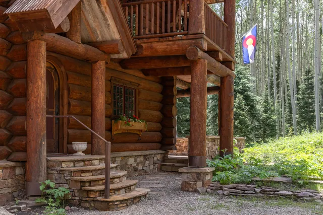 a living room with fireplace furniture and a floor to ceiling window