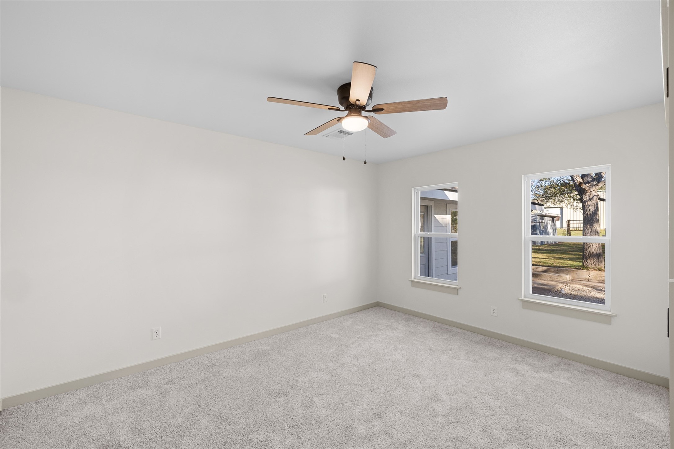911 Eilers Street Schulenburg, TX 78956 - Photo 17 of 22 an empty room with windows and fan