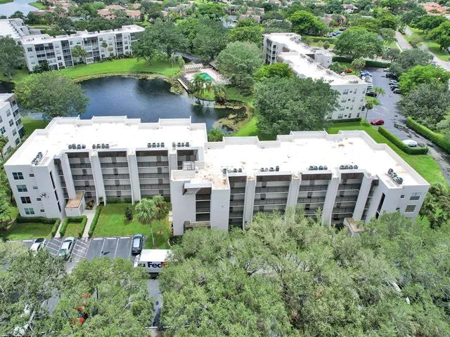 an aerial view of a house with a yard and lake view