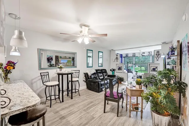 a living room with furniture a large window and a chandelier