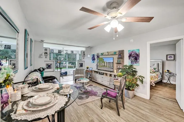 a living room with furniture large window and a table