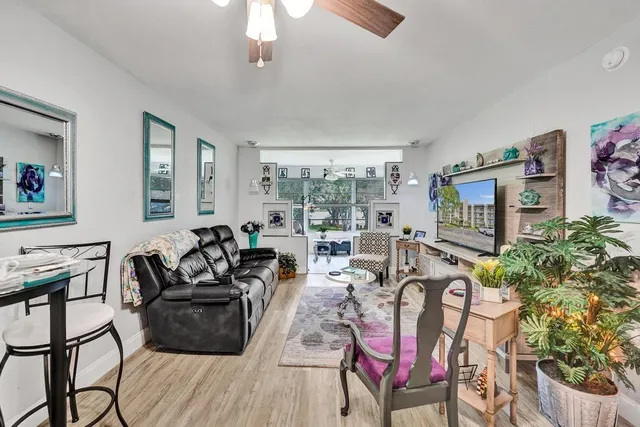 a living room with furniture a rug and a fireplace