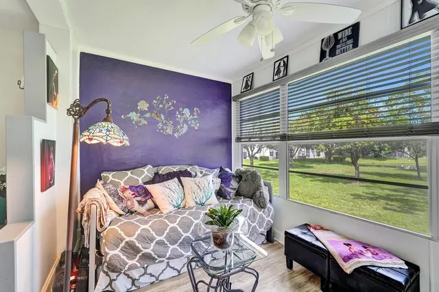 a bedroom with a bed and ceiling fan