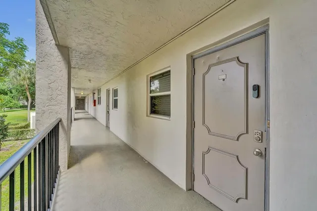 a view of a hallway with a white stove and a wooden floor