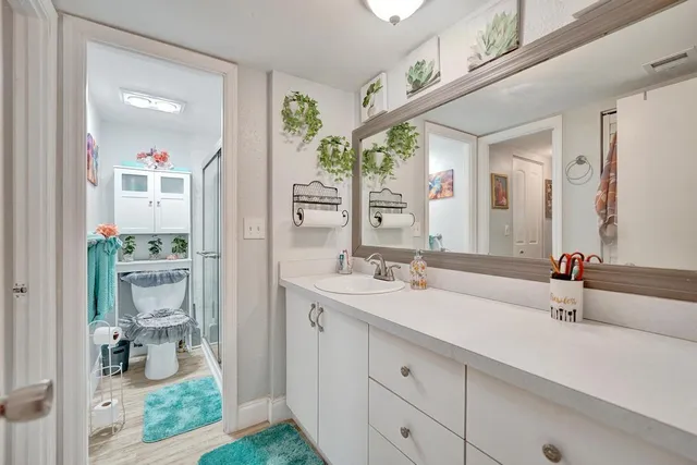 a view of a building with a big yard and large trees