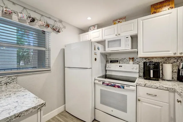 a view of a dining room with furniture and a chandelier