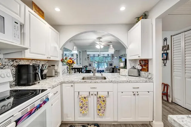 a living room with furniture a wooden floor and next to a window