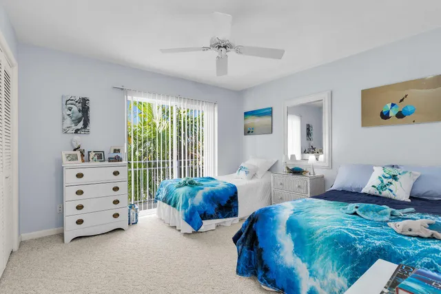 a bedroom with two beds and a window