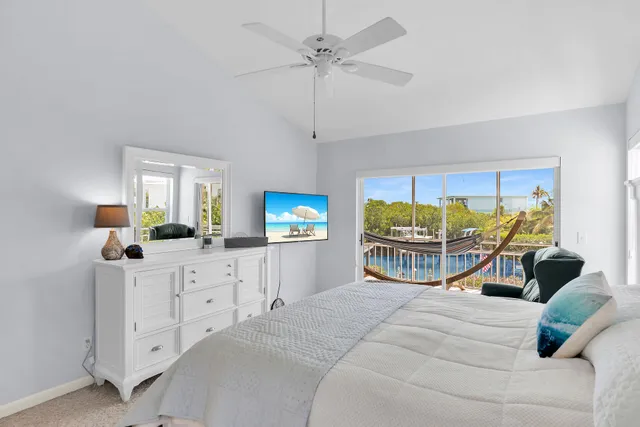 a bedroom with a bed a dresser and a flat screen tv