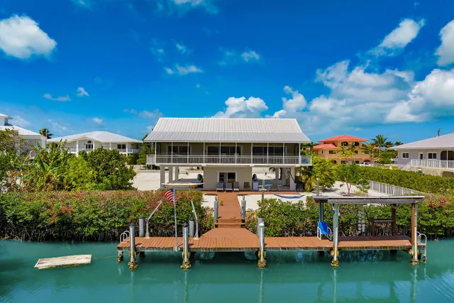 a patio area with table and chairs under an umbrella