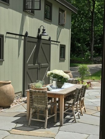16 Pinecroft Road Weston, MA 02493 - Photo 17 of 18 a view of a patio with table and chairs and potted plants