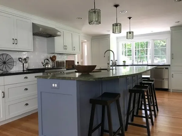 a kitchen with a sink a counter space appliances and cabinets