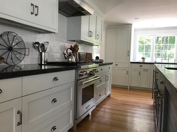 a kitchen with stainless steel appliances granite countertop a sink a stove and cabinets